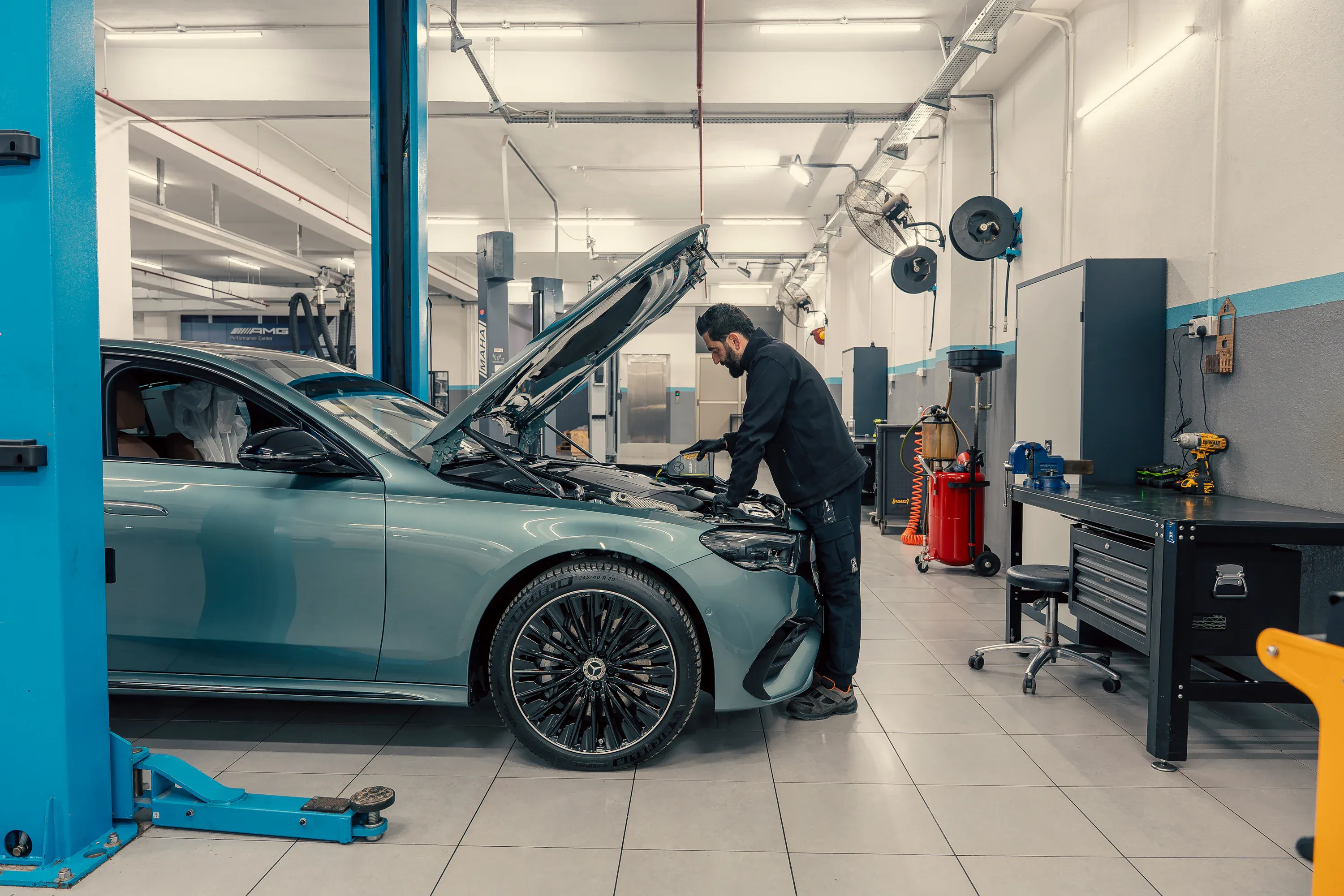 Mechanic inspecting a vehicle engine in an automotive workshop