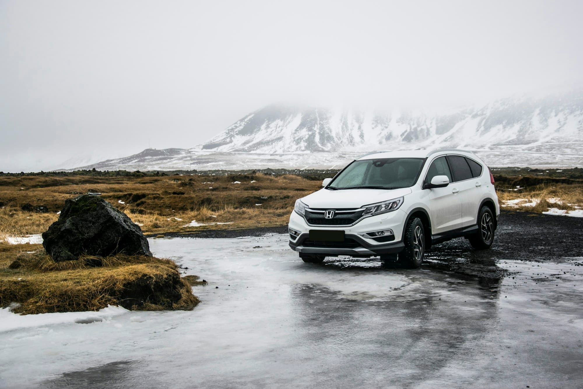 White Honda CR-V on a winter mountain road