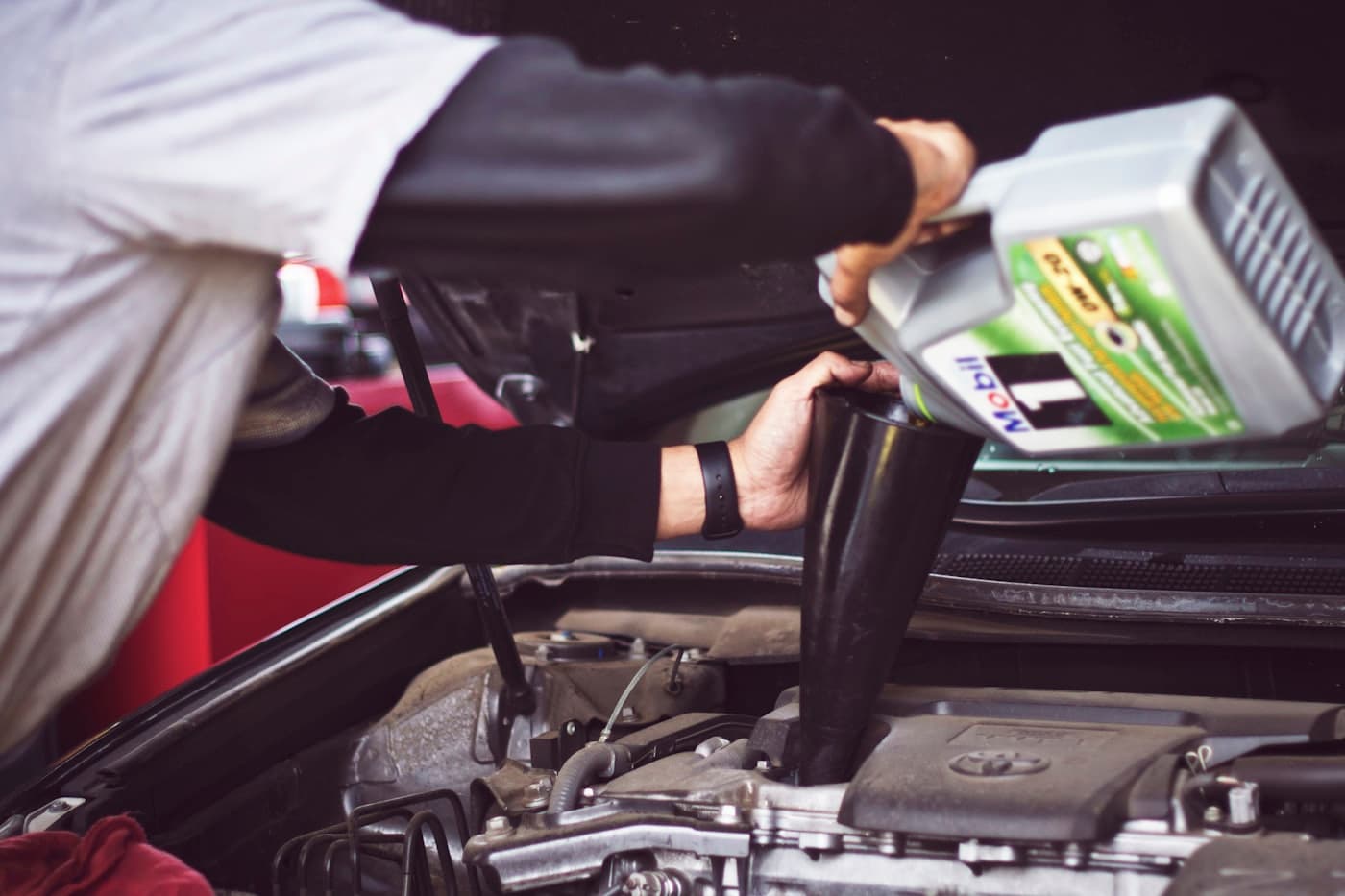 Technician inspecting an engine in a service bay